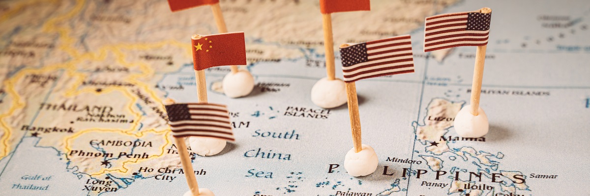 Flags of china and the united states on a map of the southern china sea.