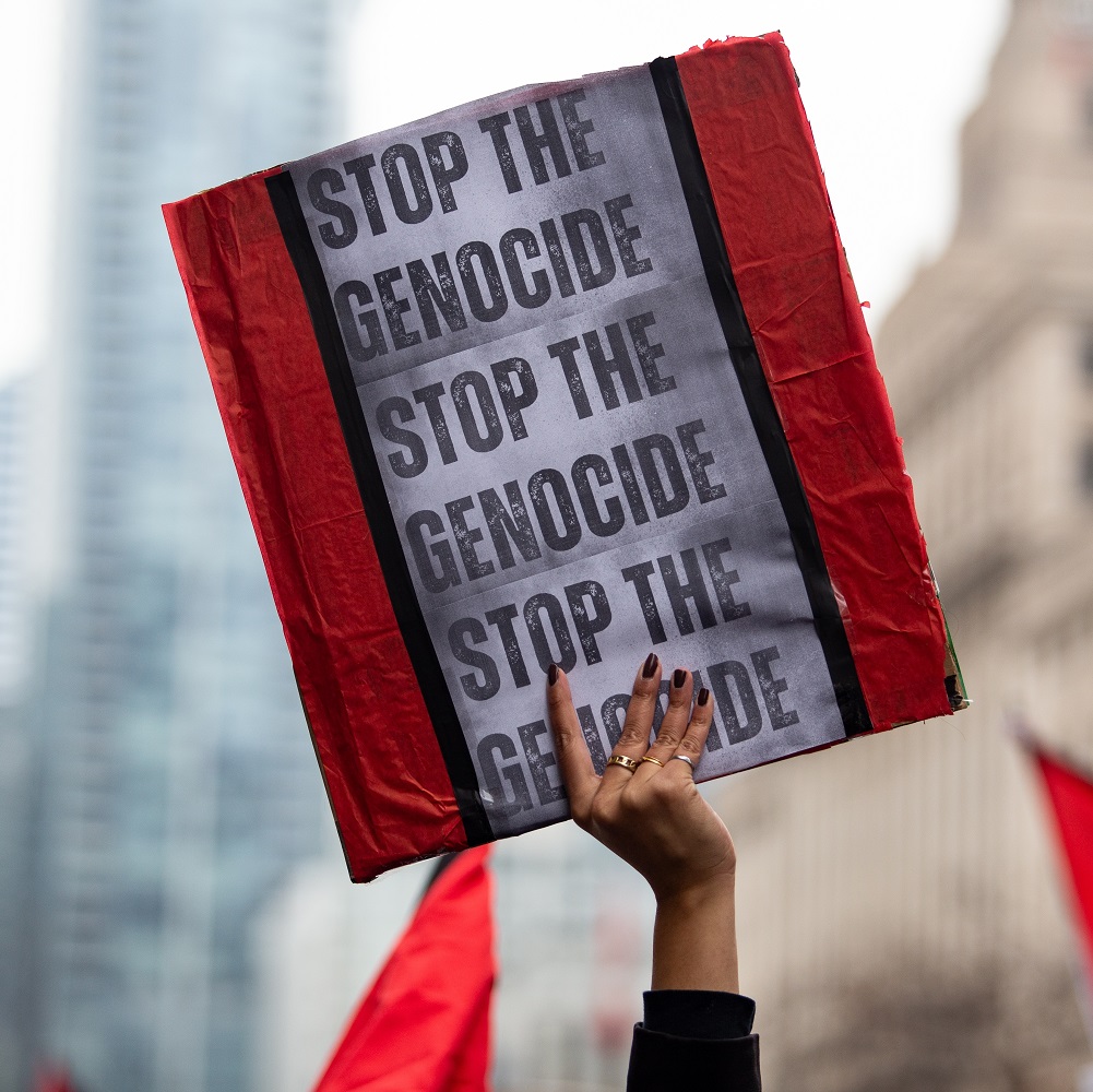 Person holds up a sign saying Stop the Genocide at a Palestinian demonstration Toronto Canada against the war in Gaza