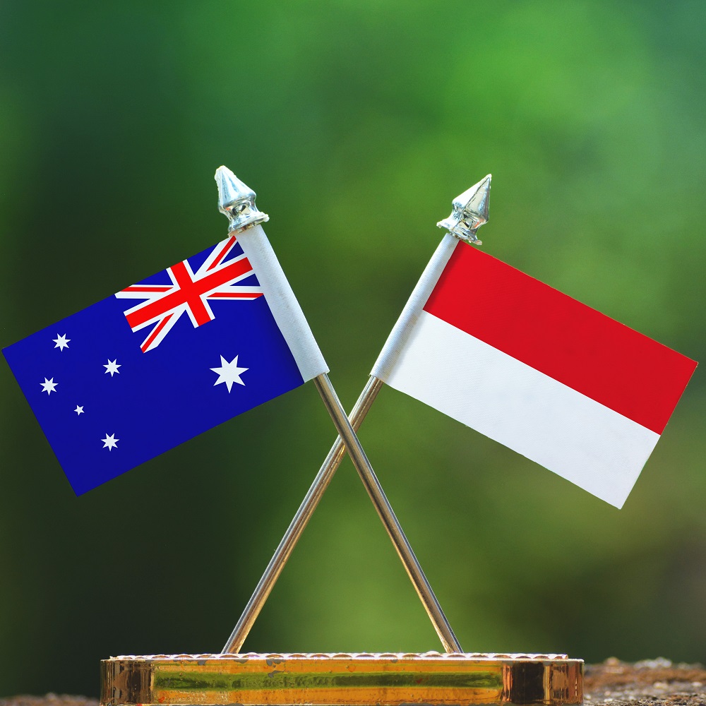 Indonesia and Australia small flag with blur green background