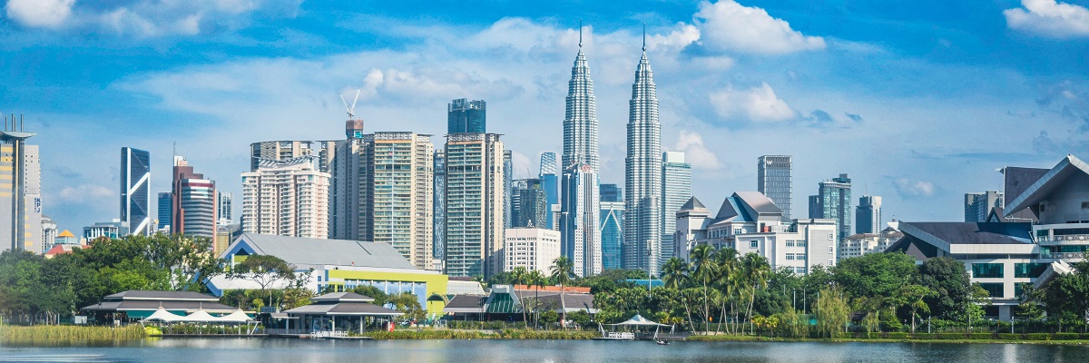 Skyscrapers of modern urban architecture and high-rise buildings with the Petronas twin towers, city centre of Kuala Lumpur.