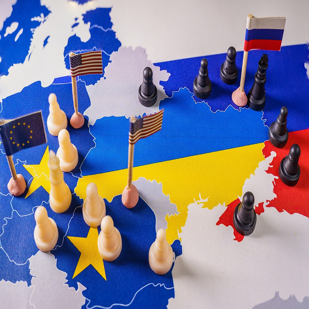 EU, USA and Russian flags with chess pieces symbolizing the conflict and control of Ukraine