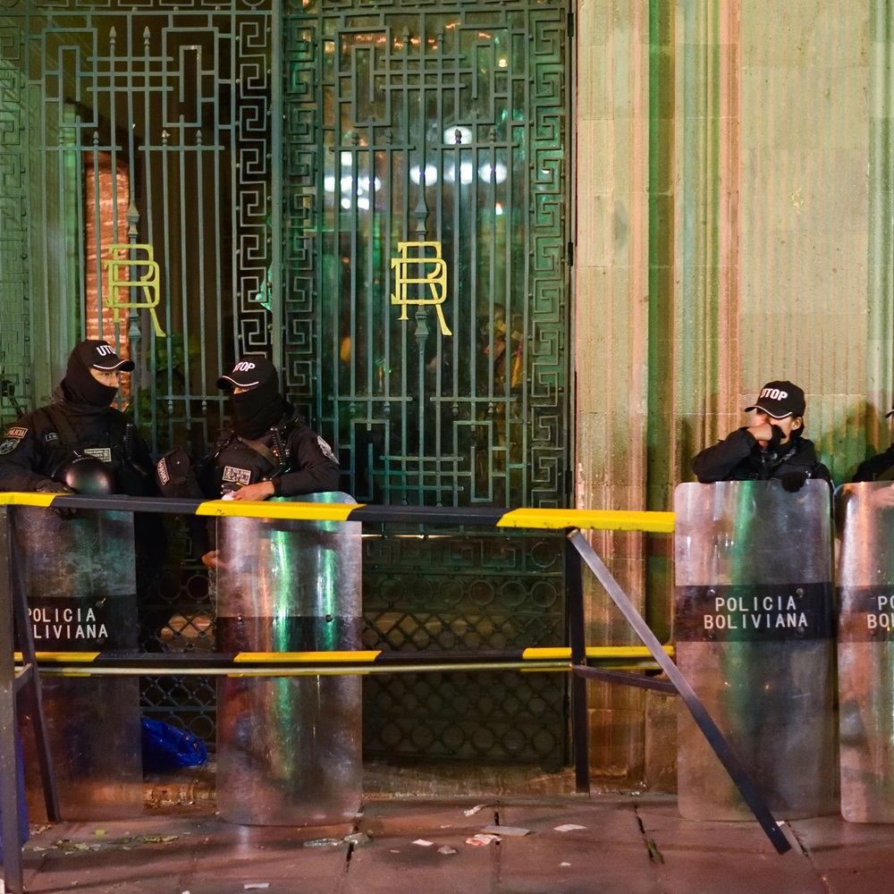 LA PAZ, BOLIVIA - JUNE 26, 2024: Bolivian National Police in Riot Gear Guarding Door of Presidential Palace after Failed Military Coup