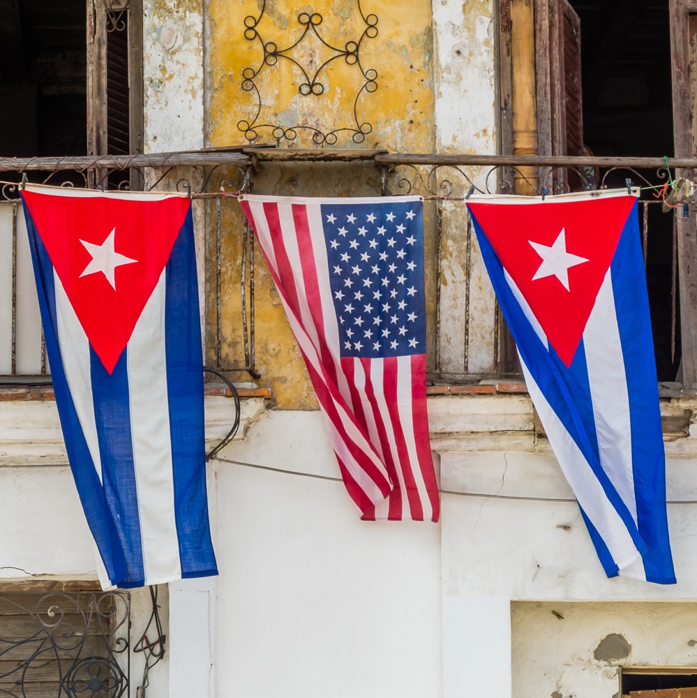 HAVANA - MAR 20 2016 - An unknown enthusiastic local reacts to President Obama´s visit to Cuba hanging both Cuban and American flags on his balcony.