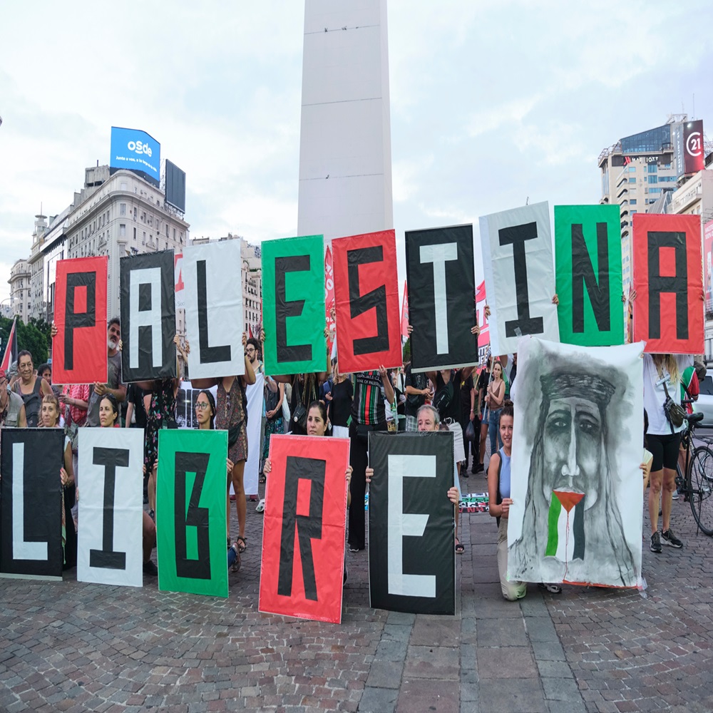 Buenos Aires, Argentina, Feb 16, 2024: People protesting in front of the obelisk, downtown, with posters in the colors of the Palestinian flag forming the text Free Palestine.