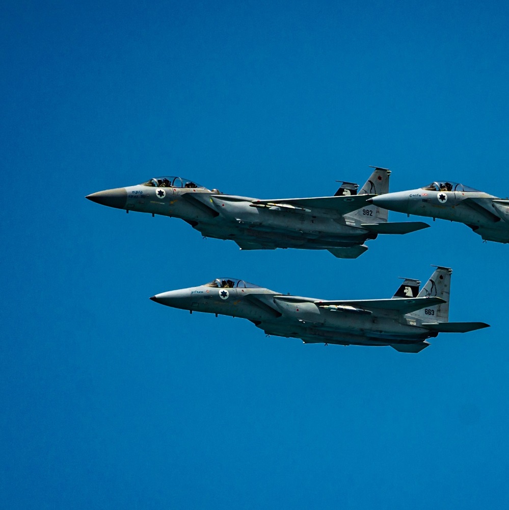 TEL AVIV, IL - May 05, 2022: Three fighter jets flying in formation in front of a stunning beach in Tel Aviv, Israel