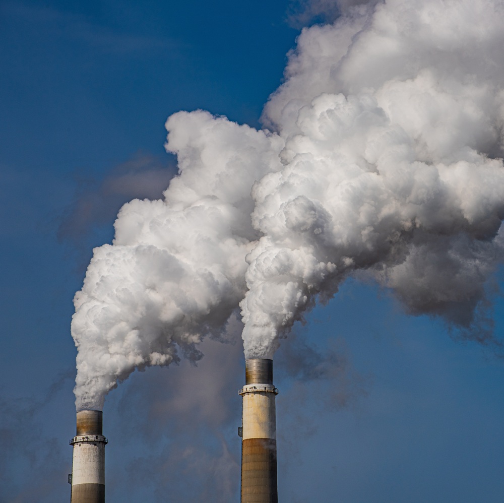 Exhaust stacks from coal fired power plant emitting waste products to atmosphere.