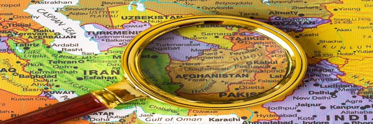 Afghanistan a map of Asia in a defocused magnifying glass, the theme of travel and trips to Afghanistan, Kabul, selective focus