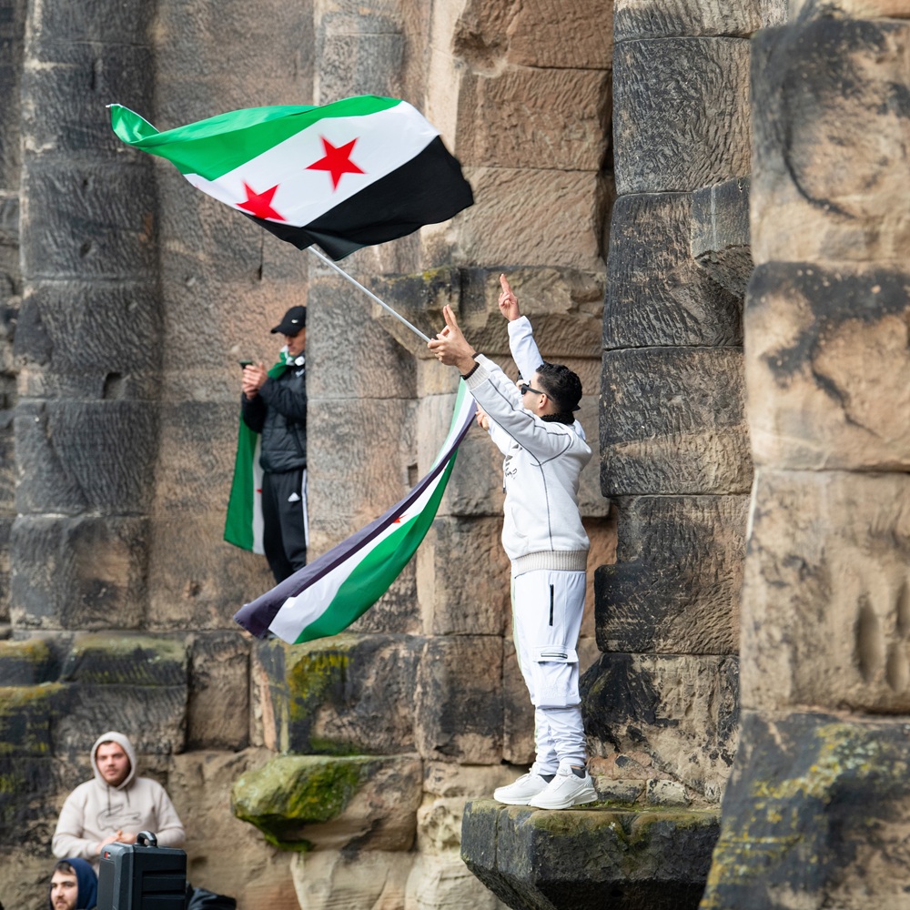 Syrians celebrate after Assad regime toppled, war in the middle east, rebels and islamists, Porta Nigra in Trier, Germany, 08.12.2024