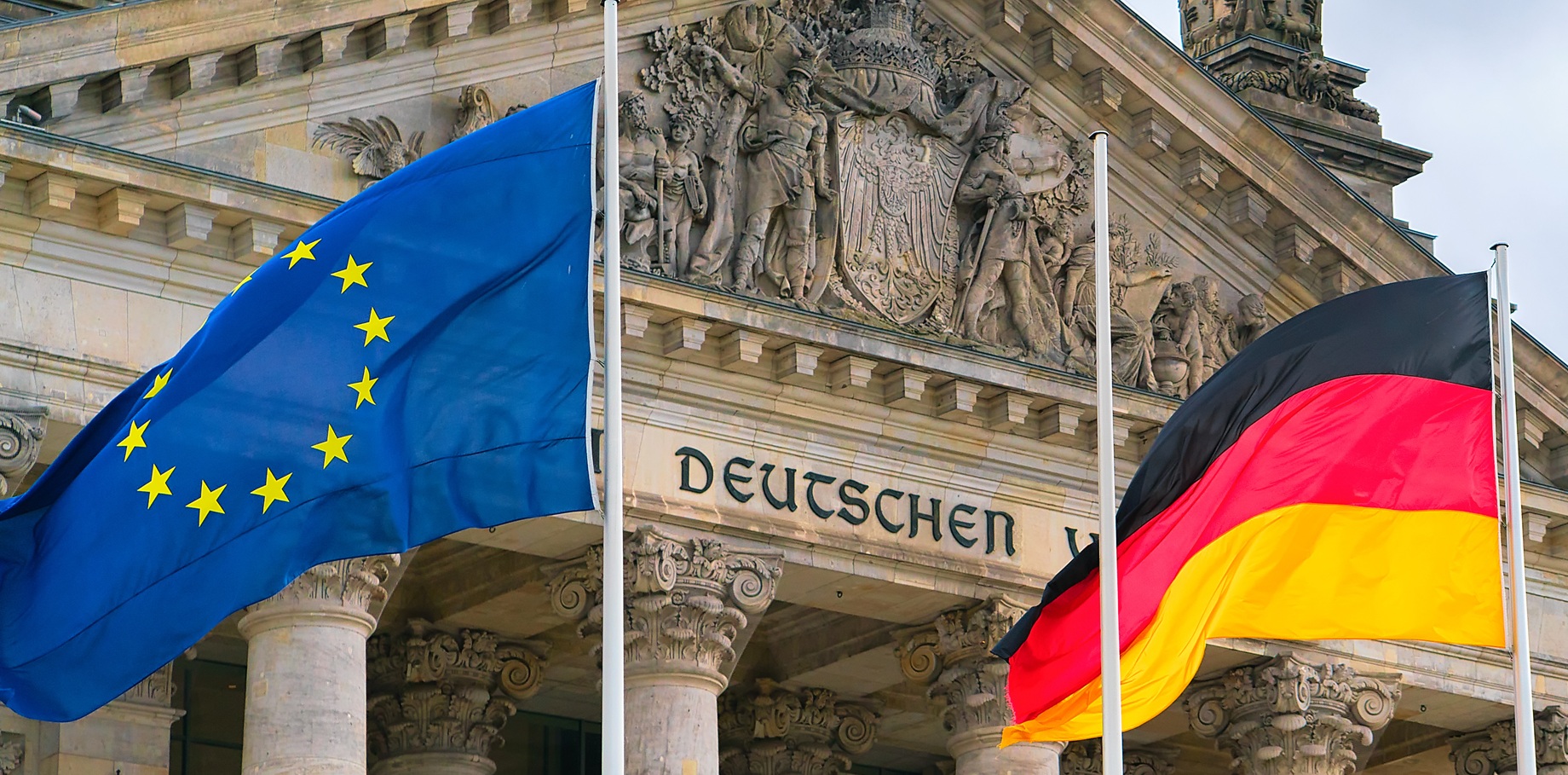 Berlin, Germany - December 8, 2017: Detail of Reichstag building and German and EU Flags in Berlin, capital of Germany
