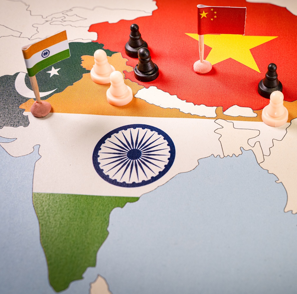Chess pieces over a map of Idnia and China. India-China Border Dispute . Selective focus