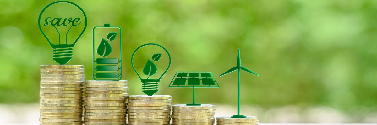 Alternative or renewable energy financing program, financial concept : Green eco-friendly or sustainable energy symbols atop five coin stacks e.g a light bulb, a rechargeable battery, solar cell panel