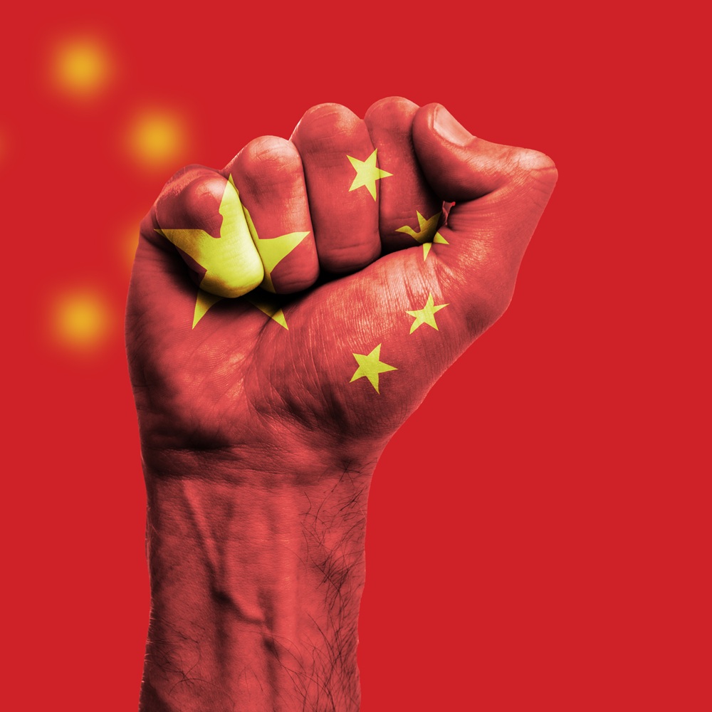 China flag painted on a clenched fist. Strength, Power, Protest concept