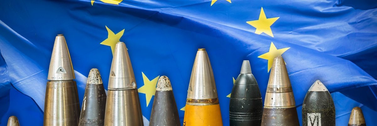 Military bombs and ammunition in front of a waving European Union flag
