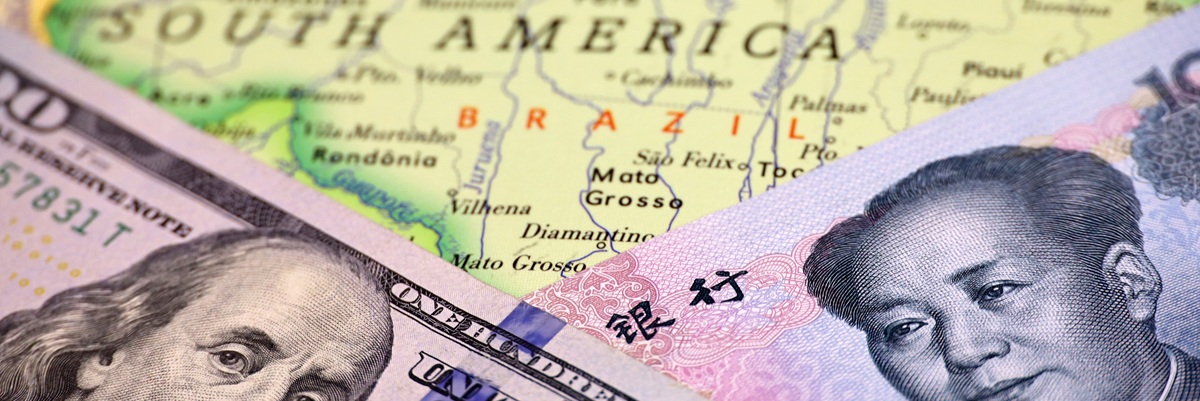 US dollar and Chinese yuan on the map of Brazil. Economic competition between the China and USA in Latin America countries