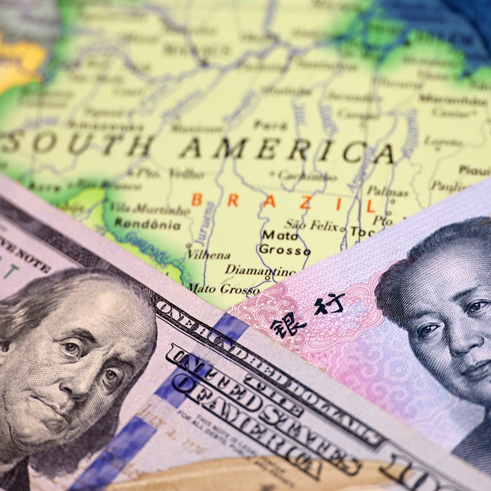 US dollar and Chinese yuan on the map of Brazil. Economic competition between the China and USA in Latin America countries
