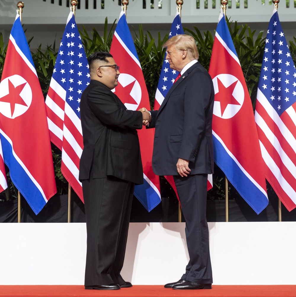 Kim and Trump shaking hands at the red carpet during the DPRK–USA Singapore Summit 2018