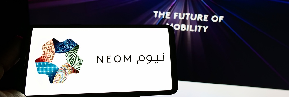 Stuttgart, Germany - 10-01-2022: Person holding cellphone with logo of Saudi Arabian property developer NEOM Company on screen in front of webpage. Focus on phone display. Unmodified photo.