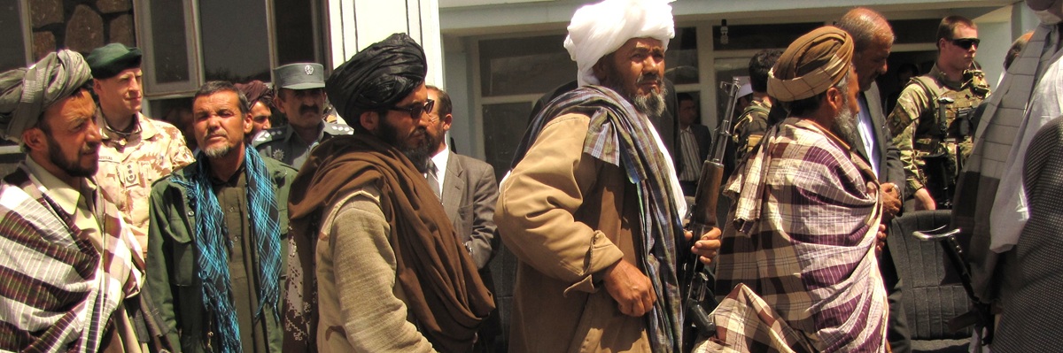Former Taliban fighters return arms