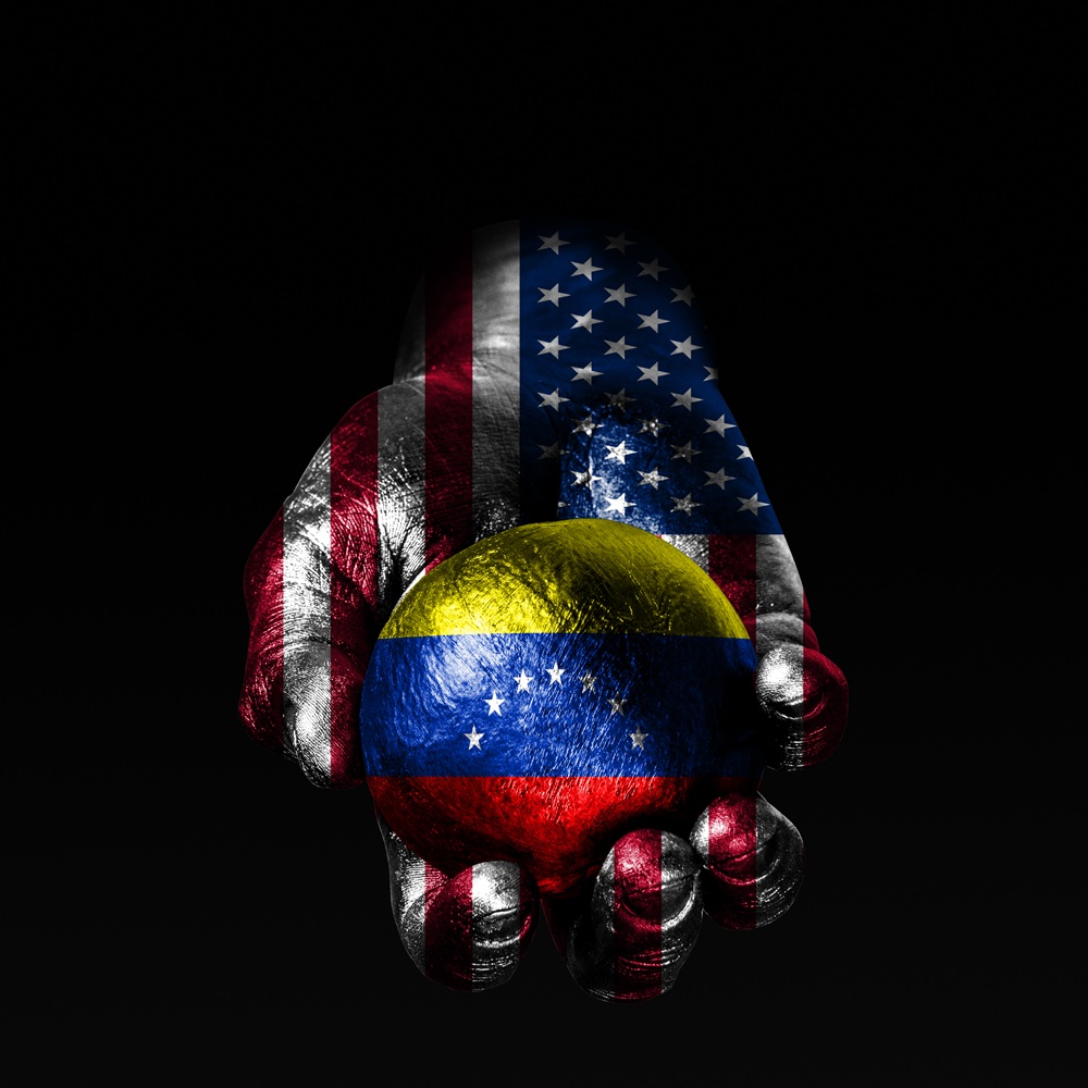 A hand with a drawn USA flag holds a ball with a drawn Venezuela flag, a sign of influence, pressure or conservation and protection. Horizontal frame